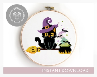 May include: Cross stitch pattern of a black cat wearing a purple witch hat and holding a broom. The cat is sitting on a branch with a cauldron of green potion bubbling below. The pattern is in a white embroidery hoop.