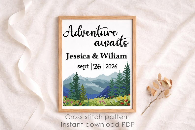 May include: A framed cross-stitch pattern with the words "Adventure awaits" above the names Jessica & Wiliam and the date Sept 26, 2026. The design features a mountain landscape with trees and flowers. The text "Cross stitch pattern Instant download PDF" is at the bottom.