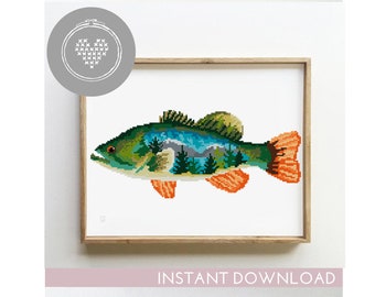 May include: Cross stitch pattern of a bass fish with a mountain landscape inside. The fish is green, orange, and blue. The pattern is in a white frame.