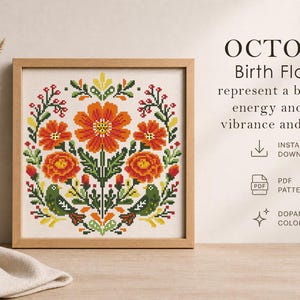 May include: A framed cross-stitch pattern featuring October birth flowers in vibrant orange, red, green, and yellow. The design includes floral elements and the text "OCTOBER Birth Flowers". The artwork is displayed with dried wheat in a vase.
