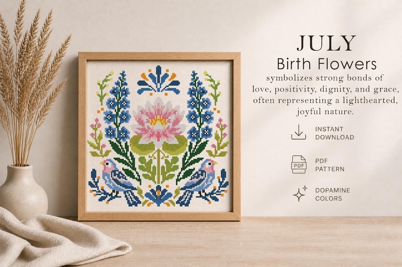 May include: A framed cross-stitch pattern featuring July birth flowers. The design includes a pink water lily, blue flowers, green leaves, and two birds. The text reads "JULY Birth Flowers" and mentions "Instant Download" and "Dopamine Colors."