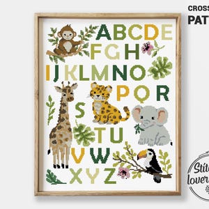 May include: A framed cross-stitch pattern featuring the alphabet with jungle animals. The letters are in green and yellow, with a monkey, giraffe, leopard, elephant, and toucan. The text "CROSS STITCH PATTERN" is at the top.