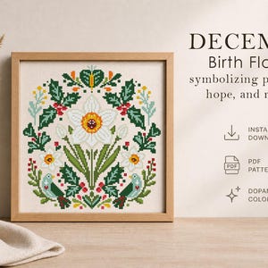 May include: A framed cross-stitch pattern featuring a white daffodil with a yellow center, surrounded by green leaves, red berries, and small birds. The text reads "DECEMBER Birth Flowers" and "symbolizing protection, hope, and renewal."