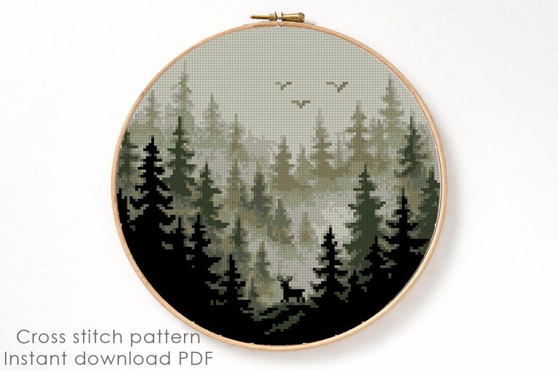 May include: A cross-stitch pattern of a forest scene, featuring tall evergreen trees in shades of green and black, with a deer silhouette. The design is set within a round wooden embroidery hoop. The text "Cross stitch pattern Instant download PDF" is at the bottom.