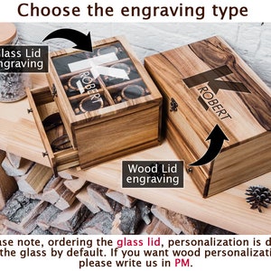 May include: A wooden box with a glass lid and a drawer. The lid and drawer can be engraved with a name. The box is shown on a wooden surface. The text on the box reads "ROBERT".