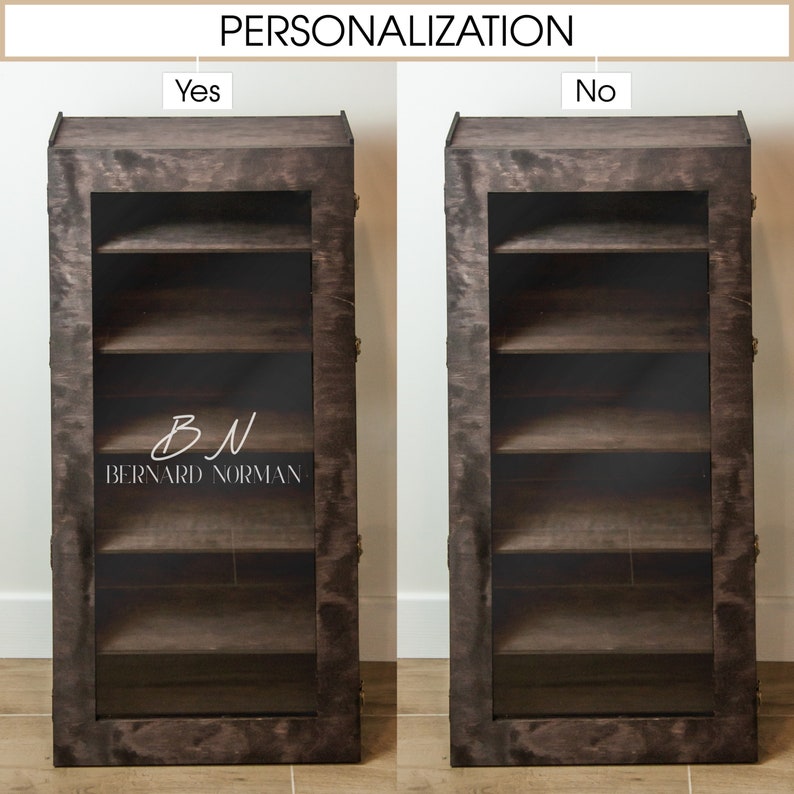 May include: A dark brown wooden cabinet with glass doors and four shelves. The cabinet has a personalized inscription that reads "BN BERNARD NORMAN".