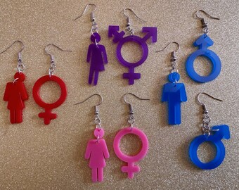 May include: A set of eight earrings featuring various gender symbols. The earrings are made of acrylic and come in pink, purple, red, and blue.
