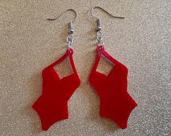 May include: A pair of red geometric earrings with a cutout design. The earrings are made of acrylic and have silver hooks.