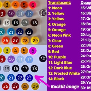 May include: A chart showing 30 different color options for round, numbered, plastic discs. The chart is divided into two sections: Translucent and Opaque. Each color option is numbered 1 through 30. The text "Backlit image" is written below the chart. The text "*Limited, +$3 fee applies when available" is written to the right of the chart.