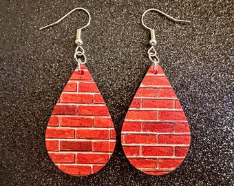 May include: A pair of red brick pattern teardrop dangle earrings with silver hooks.