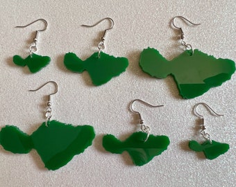 May include: Five pairs of green acrylic earrings shaped like the island of Hawaii. The earrings are on a white background.