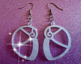 May include: A pair of white acrylic earrings shaped like a nautilus shell. The earrings have a silver hook.