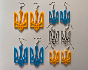 Puede incluir: Un conjunto de seis pendientes con el símbolo del tridente ucraniano. Los pendientes están disponibles en tres colores: amarillo, azul y plateado.