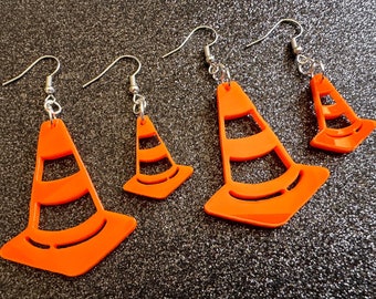 May include: Four pairs of orange traffic cone shaped earrings. The earrings are made of acrylic and have a shiny finish.