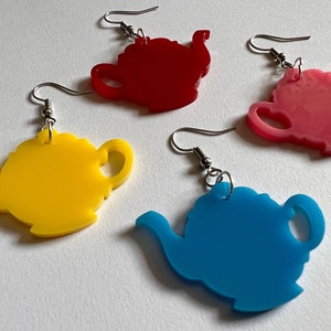 May include: Four pairs of teapot-shaped earrings. The earrings are made of acrylic and come in four colors: red, pink, yellow, and blue.