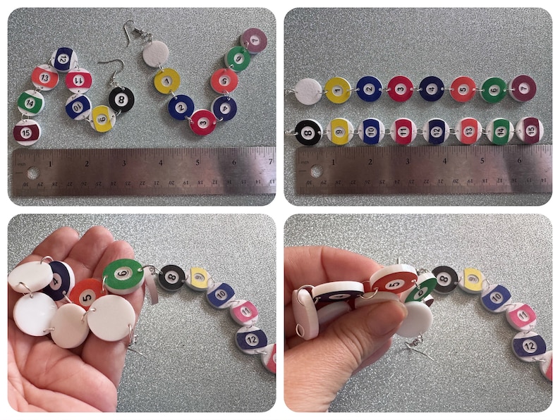 May include: A pair of earrings made from white plastic circles with numbers 1 through 15 printed on them, resembling billiard balls. The earrings are connected by silver jump rings. The earrings are shown on a ruler, measuring approximately 6 inches in length.