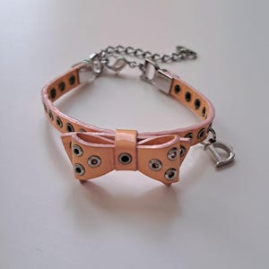 Christian Dior vintage 1990&#39;s pink peach bow bracelet. With silver studs and dior logo, signed Y2K