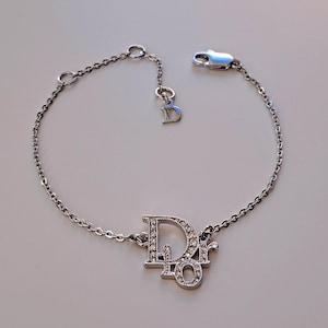 Christian Dior vintage diamante bracelet 2000&#39;s. Silver tone spellout oblique with pouch