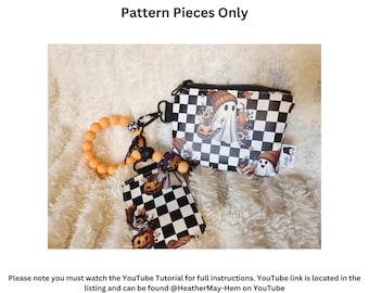 May include: A black and white checkered wallet and card case with a Halloween theme. The wallet features a zipper closure and a design with ghosts and pumpkins. The image also includes a matching keychain and the text "Craft Show Wallet & Card Case".