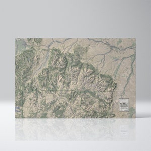 May include: A rectangular map of the Beartooth Mountains, featuring a detailed topographical representation. The map uses a muted color palette of greens, tans, and browns to depict the terrain. The map includes the text "Beartooth Mountains".