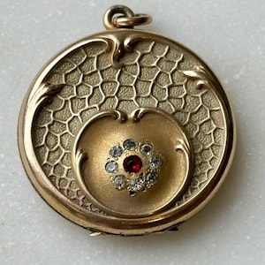 May include: A white ceramic mug with a black handle and the text "But First, Coffee" in a black, bold font. The mug is sitting on a wooden surface. The mug is approximately 4 inches tall.