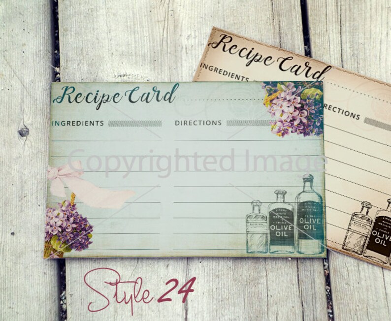 May include: Two vintage-style recipe cards with a blue and white design. The cards have lines for writing ingredients and directions. The cards feature a floral design and a drawing of bottles of olive oil.