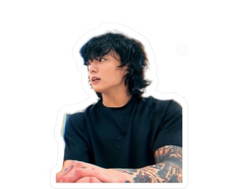 May include: A young man with black hair and a black t-shirt. He has tattoos on his arm.