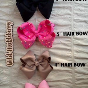 May include: Four hair bows arranged vertically. The top is black, labeled 6" HAIR BOW. The second is pink with multi-colored sprinkles, labeled 5" HAIR BOW. The third is tan, labeled 4" HAIR BOW. The bottom is light pink, labeled 3" HAIR BOW.