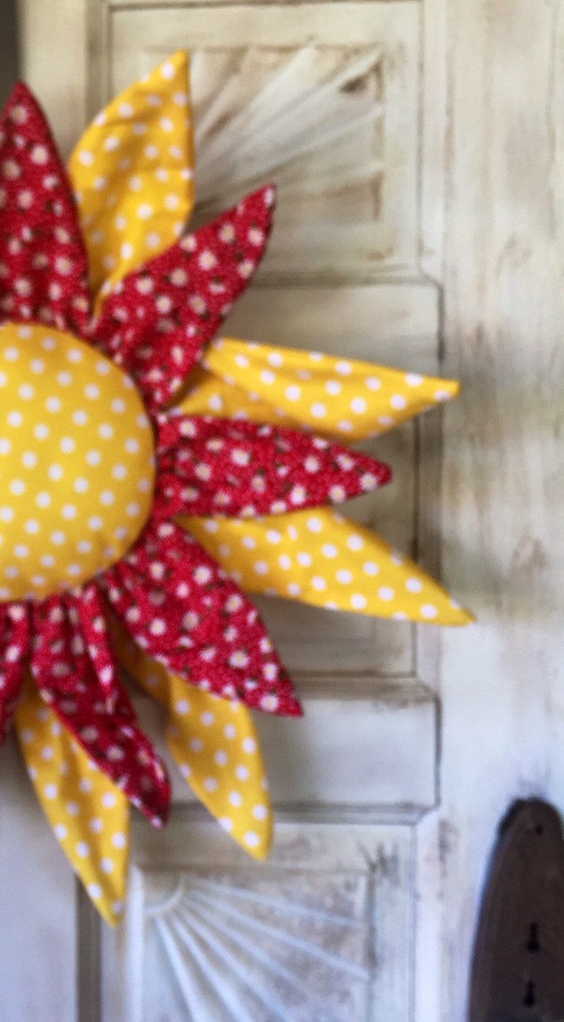 Adorable yellow and white paired with a cute red with white daisies door hanger