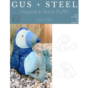 May include: A blue and white fabric puffin toy with a black eye. The toy is sitting on a bed of small white rocks. The image also includes a line drawing of the puffin toy.