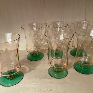 May include: Set of six vintage pink and green glass tumblers. The glasses have a wavy, textured design and are perfect for serving drinks.