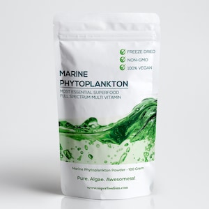 May include: A white pouch with a green wave design. The pouch contains Marine Phytoplankton Powder, a superfood with a full spectrum of vitamins. The pouch is labelled as freeze-dried, non-GMO, and 100% vegan. The text on the pouch reads "Marine Phytoplankton Powder - 100 Gram, Pure. Algae. Awesomess! www.superfoodism.com"