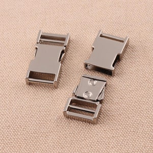 May include: Three silver metal side release buckles. The buckles are designed for use with webbing or straps.