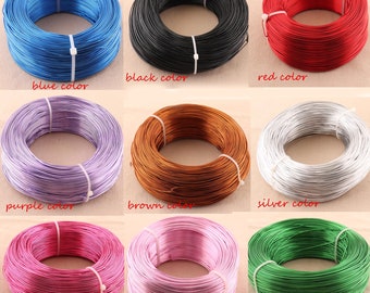 May include: Nine spools of colorful wire, each wound into a coil. The colors are blue, black, red, purple, brown, silver, rose red, pink, and green.