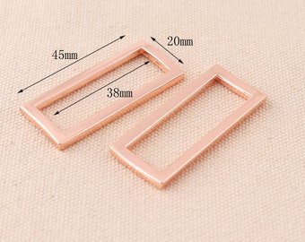 May include: Two rose gold metal rectangular frames, one measuring 4.5 inches by 3.8 inches and the other measuring 2 inches by 3.8 inches.