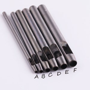 May include: Seven metal hole punch tools of varying sizes, labeled A through F. The tools are arranged in order of size, with the smallest tool on the left and the largest tool on the right.