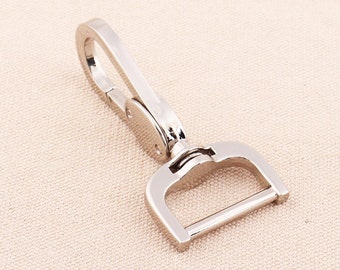 May include: Silver swivel hook with a D-ring. The hook is designed to attach to a belt loop or other item.