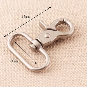 May include: Silver-toned metal swivel clasp with a 4.7 inch long hook and a 1.2 inch wide oval loop.