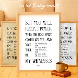 May include: Three framed prints with the text "BUT YOU WILL RECEIVE POWER WHEN THE HOLY SPIRIT COMES ON YOU AND...MY WITNESSES." A mug and a book are in front of the prints. The prints are in wooden frames.