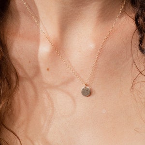 May include: A gold chain necklace with a small, round pendant. The chain is 18 inches long. The pendant is a simple, circular shape with a textured surface. The text 'chain length - 18' is visible at the bottom of the image.