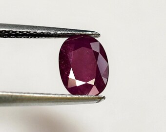 Cherry red ruby to neon pink in full sunlight, this 8x6 mm oval stone is translucent, weighs 1.59 carats and comes from Vietnam.