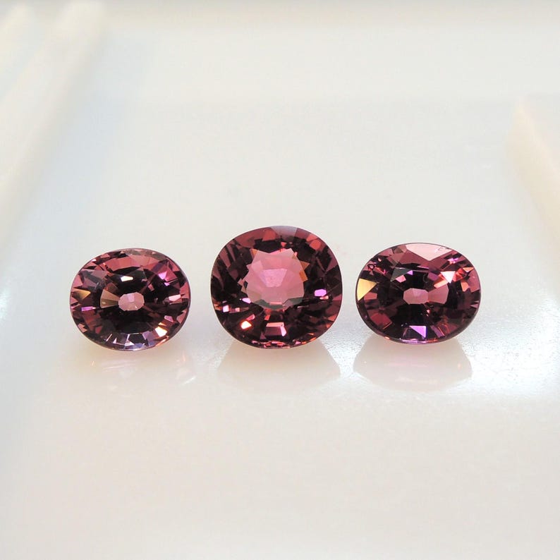 Raspberry pink tourmaline, this trio of oval and purplish-pink cushion-cut gems weighs 3.56 carats and comes from Africa image 7