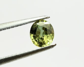 Oval yellow green sapphire 5.4x4.8 mm, this small gem weighs 0.59 carat and comes from Africa