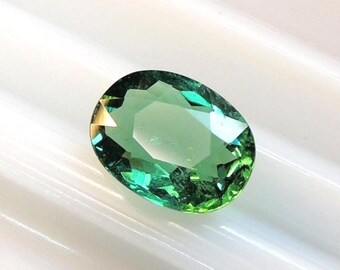 Oval cushion-shaped teal tourmaline, 7.5x9.6 mm, this bluish-green stone weighs 2.15 carats and comes from Africa