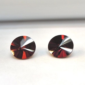 Spirit Sun fancy cut spessartine garnets, this pair of 7mm round gems weighs 3.07 carats
