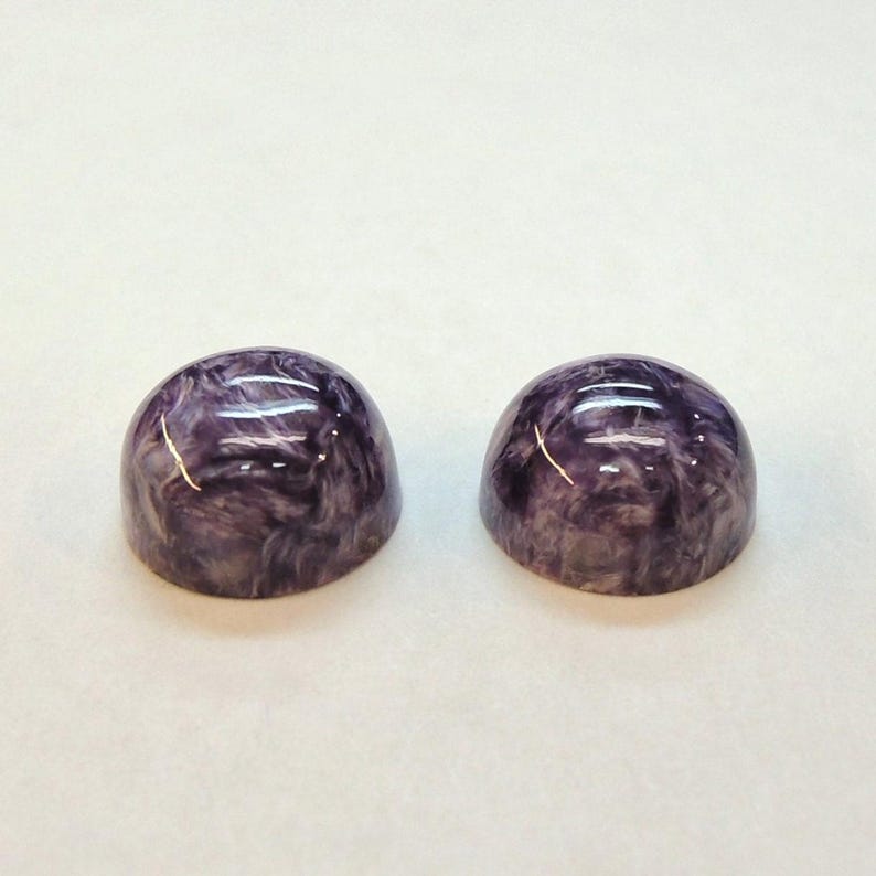Charoite pair, round 11mm cabochons, these marbled purple cabochons come from Siberia in Russia and weigh 10.67 carats. image 5
