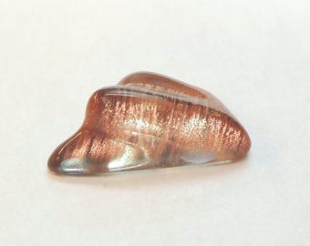 Oregon sunstone with a Schiller effect, this rare fancy-cut carved gem weighs 6.34 carats and measures 10x18 mm