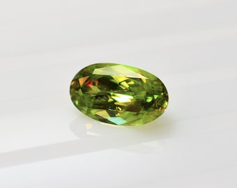 Sphene Titanite elongated oval 10.9x6.5 mm, this yellow green stone with a lot of dispersion weighs 2.54 carats and comes from Sri Lanka