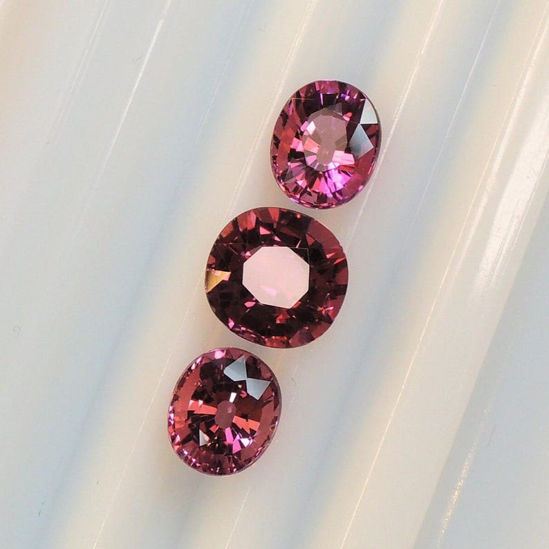 Raspberry pink tourmaline, this trio of oval and purplish-pink cushion-cut gems weighs 3.56 carats and comes from Africa image 3