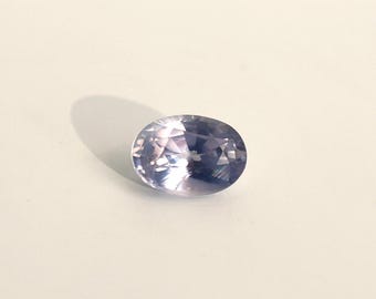 Translucent but brilliant oval milky lavender sapphire, 4.6x6.4 mm, this corundum with a slight color change towards purple weighs 0.91 carats